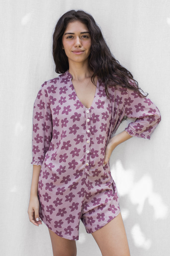 Floral Romper with small ruffle detail on the sleeve and a slight high low hem - Hawaiian Flower Print in Purple - Grape Nectar - Front View
