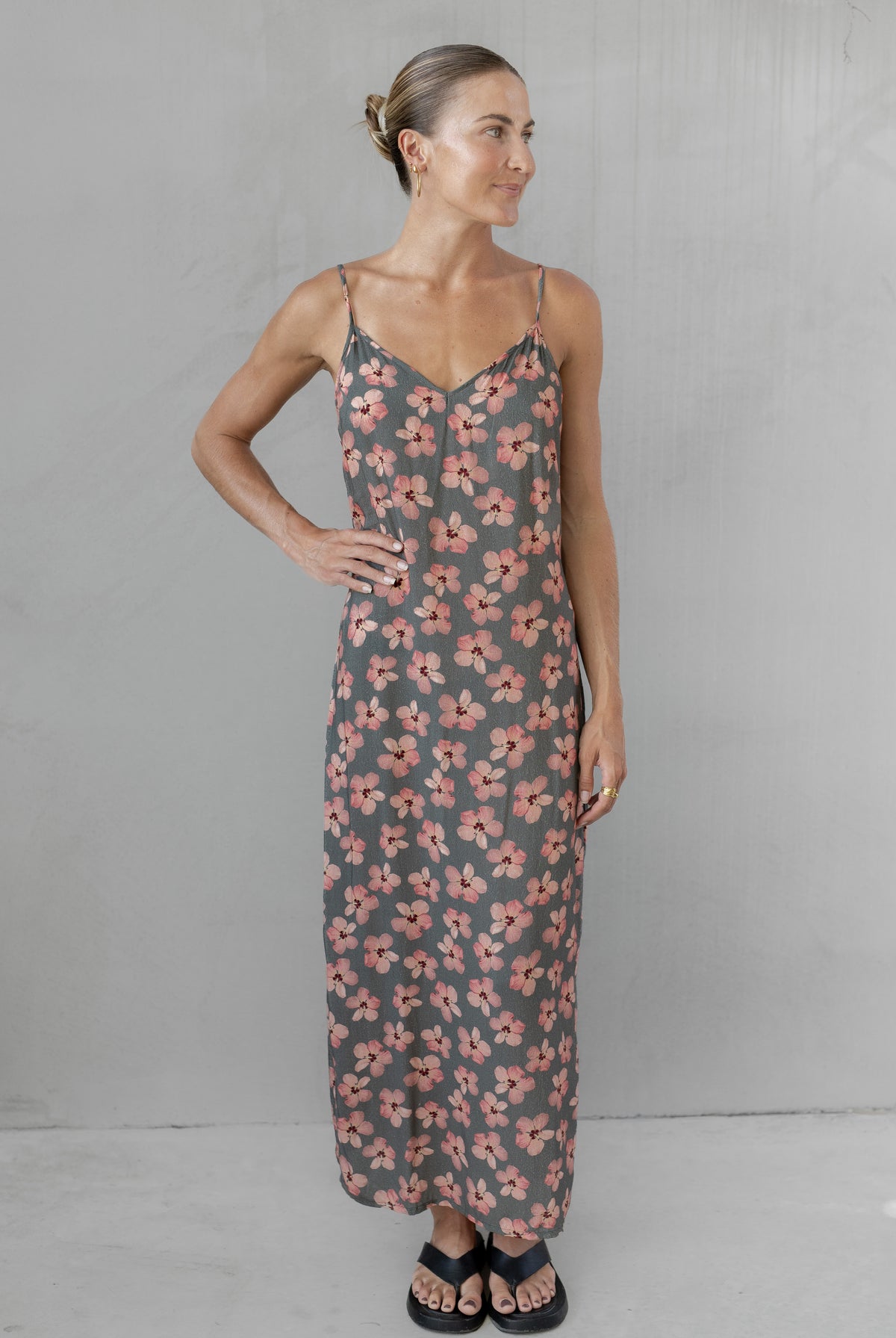 Woman wearing a floral dress against a plain background