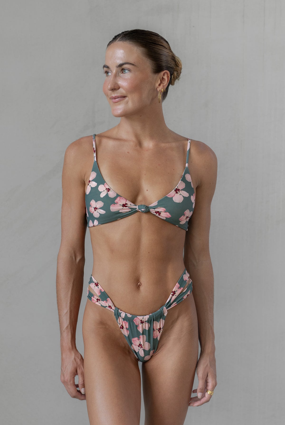 Woman wearing a floral bikini against a plain background