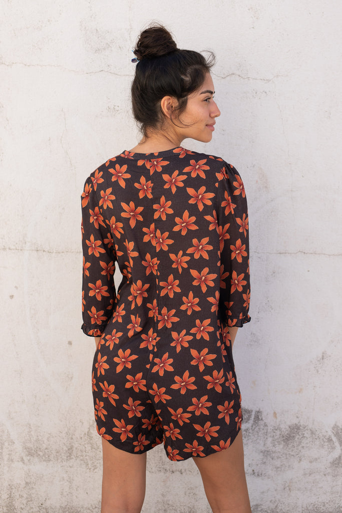 Floral Romper with small ruffle detail on the sleeve and a slight high low hem - Hawaiian Flower Print - Papaya Lily - Back View