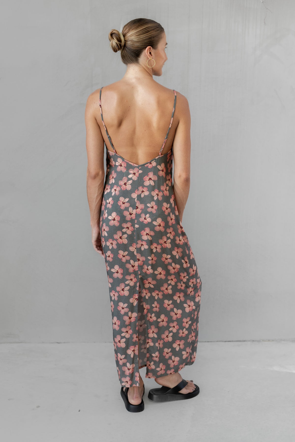 Woman wearing a floral dress with a gray background