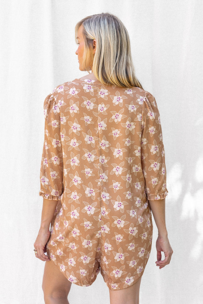 Romper with small ruffle detail on the sleeve and a slight high low hem - Hawaiian Floral Brown Print - Butterum - Back View